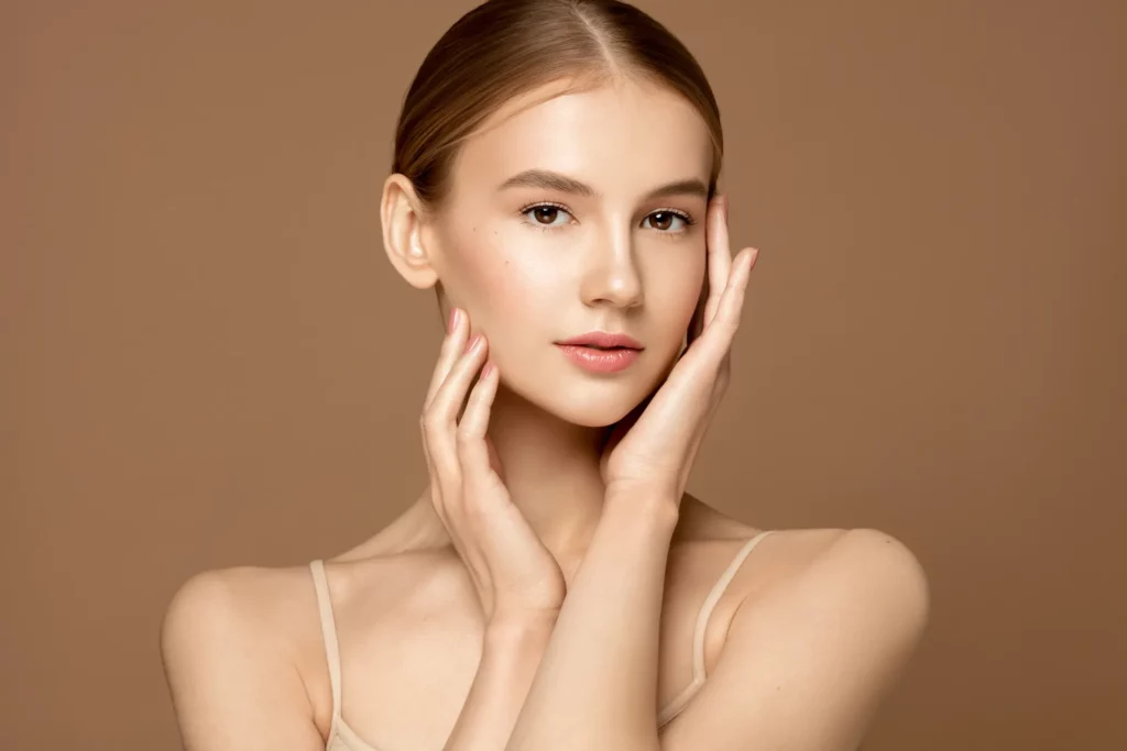Chemical Peel vs Micro-Channeling: Which Treatment Is Best for Acne Scars and Skin Rejuvenation? a woman with her hands on her face