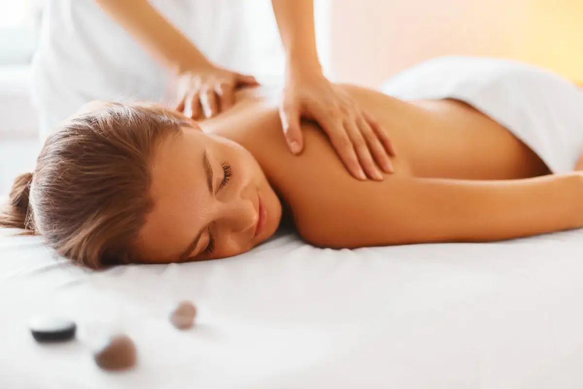 a woman lying down on a bed with her eyes closed