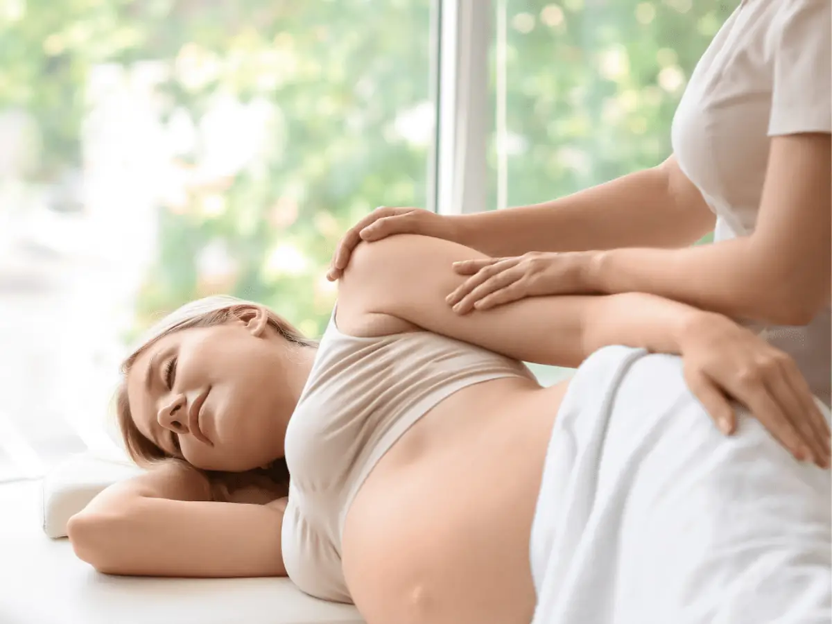 a pregnant woman lying on a bed