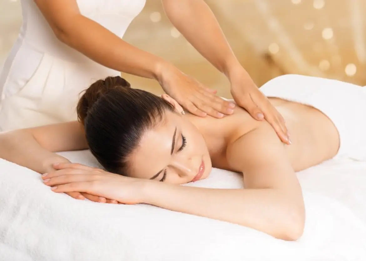a woman lying down on a white towel