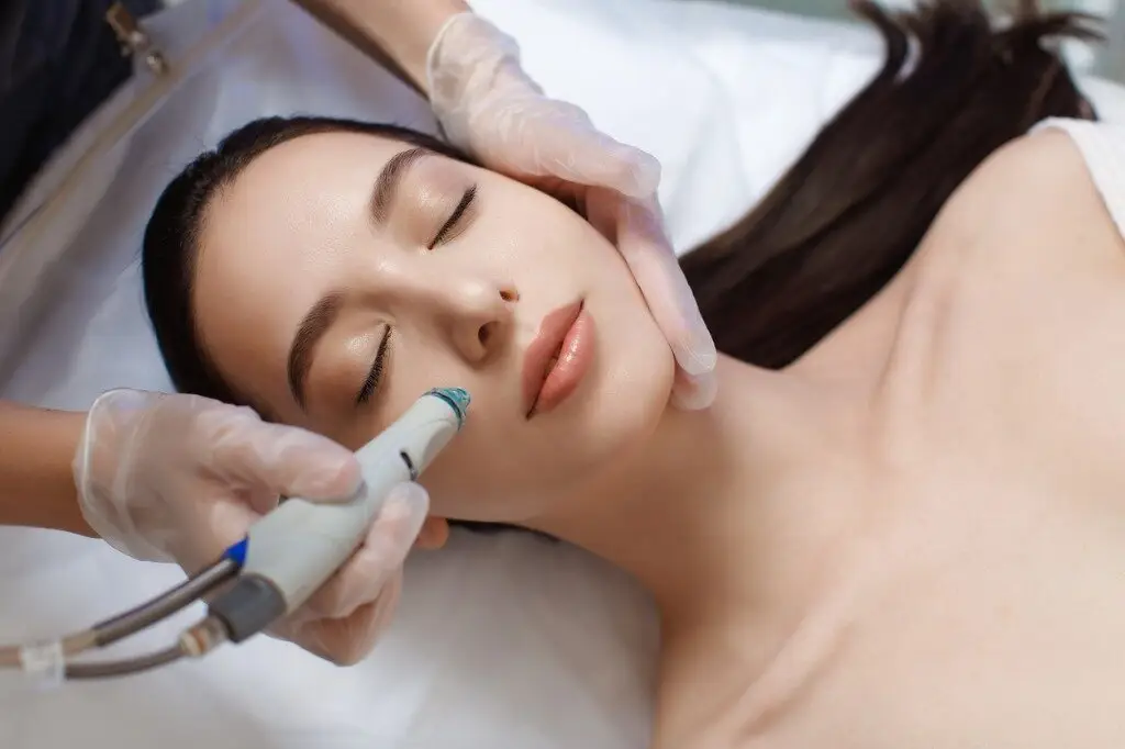 a woman receiving a face massage