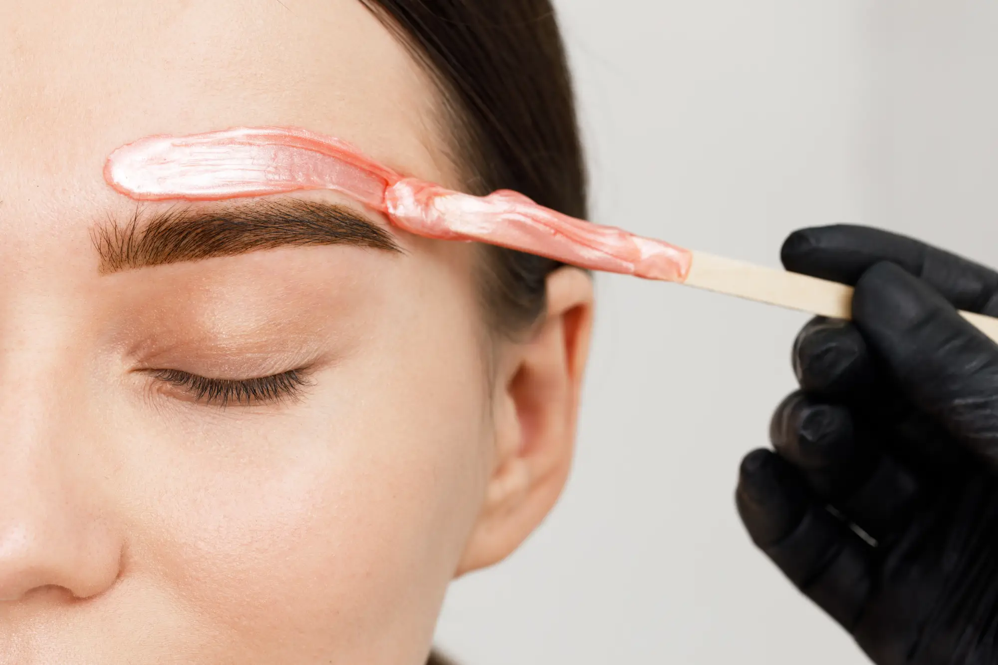 a person getting a waxed eyebrow