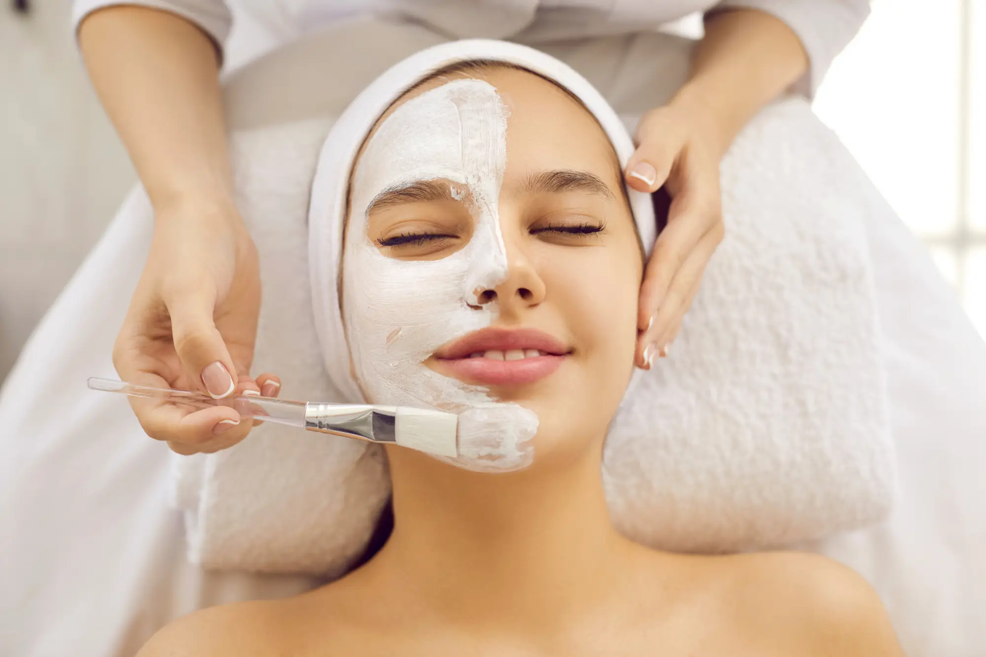 a woman getting a facial mask