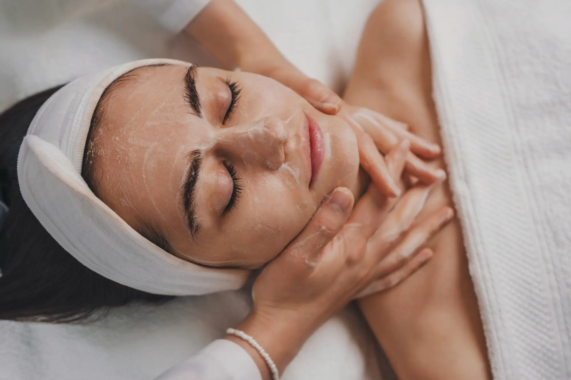a woman receiving a facial massage