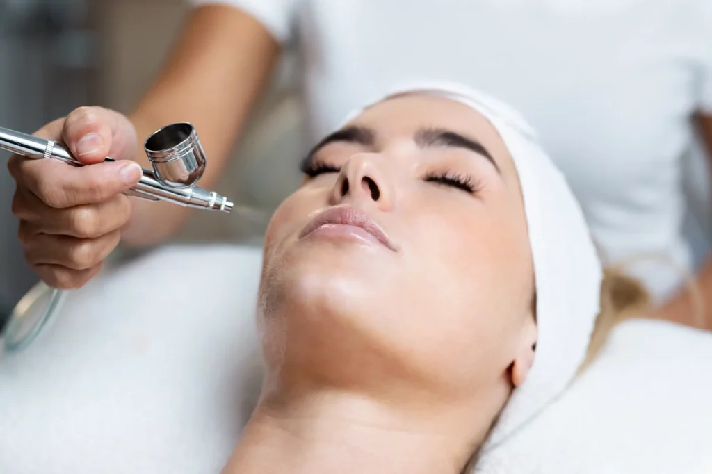 Portfolio a person using a tool to apply a face treatment